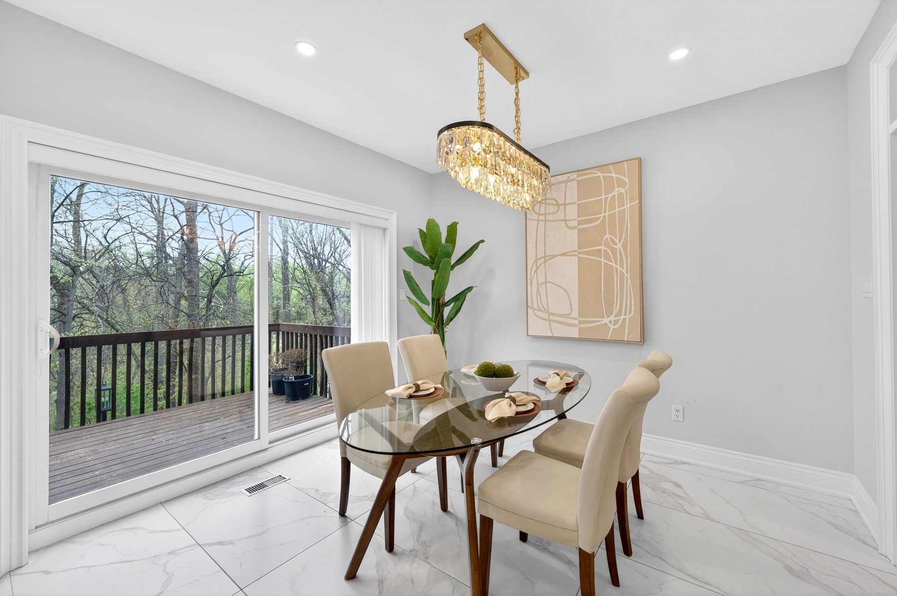 Foyer with crystal chandelier and curving staircase